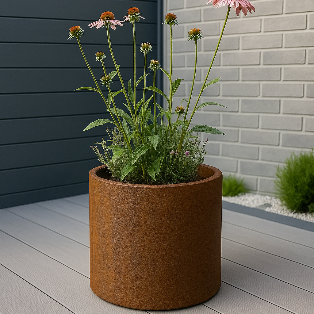 Brown metal planter with flowers on a wooden deck against a gray wall.